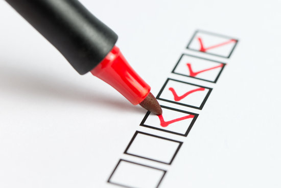 Checklist being marked with a pen